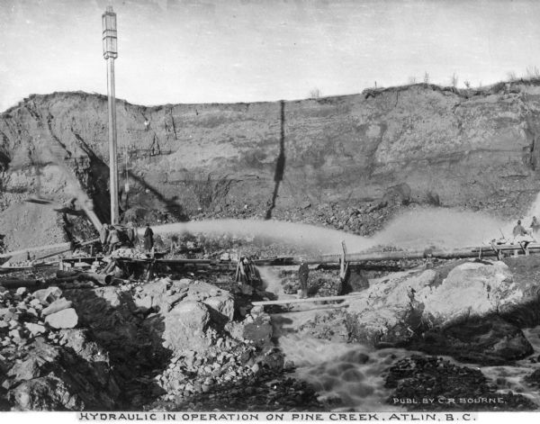 Hydraulic mining at Pine Creek, where gold was discovered in 1865, was the quickest way of mining gold deposits. Atlin was the site of the final great gold rush in Canadian history. Caption reads: "Hydraulic in Operation on Pine Creek, Atlin, B.C."