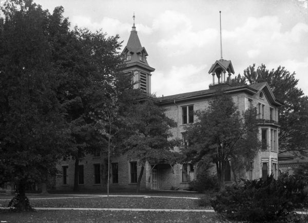 View across lawn toward the chapel at Ripon College. The roof has a central bell tower and a smaller, secondary tower to the right.