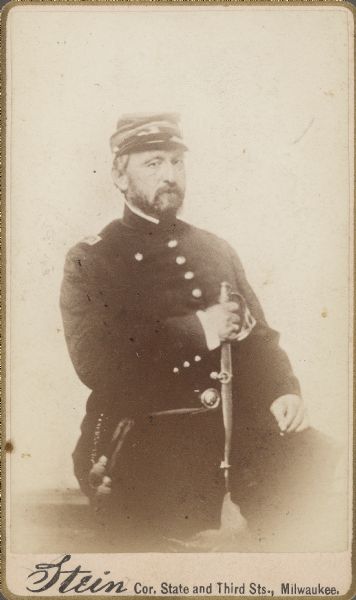 Seated carte-de-visite portrait of Captain William H. Lindwurm, Company F, 6th Wisconsin Infantry, sitting and holding his sword.