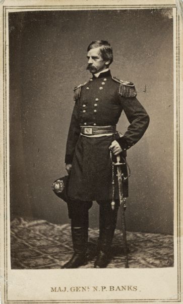 Full-length carte-de-visite portrait of Major General Nathaniel P. Banks in a uniform with epaulettes, posed with his sword in his left hand. He was born on January 30, 1816 in Waltham, Massachusetts. Prior to the Civil War he served in both the Massachusetts and the U.S. House of Representatives, as well as becoming the Governor of Massachusetts. On May 16, 1861, President Lincoln appointed him one of the first Major Generals of volunteers. By 1865 he was relieved of his field command and was used by Lincoln to lobby for his reconstruction plan.