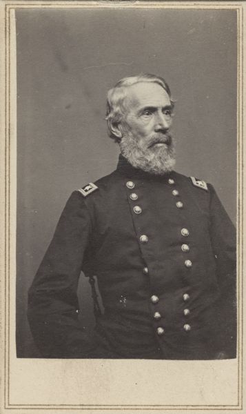 Seated, waist-up carte-de-visite portrait of Major General Edwin Vose Sumner wearing officer dress uniform. At the start of the Civil War President Lincoln promoted him to Brigadier General and assigned him to the command of the Department of the Pacific. In March 1862 he was attached to the Army of the Potomac, seeing fighting during the Peninsular Campaign. For his actions during the campaign he was appointed to Major General of volunteers. Before he relieved himself of command, he also fought in the Battles of Antietam and Fredericksburg.