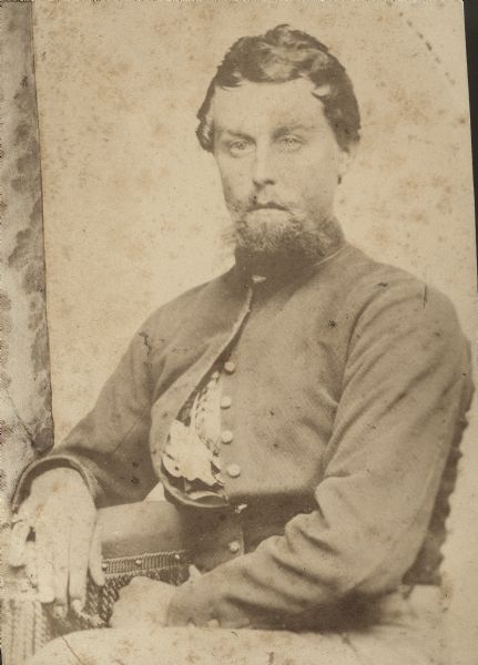 Seated portrait of Thomas J. Stewart (b. 1842), Company C, 4th Wisconsin Cavalry. He enlisted on November 2, 1863 and was mustered out of service as a corporal on July 8, 1865. He was killed in May 1870 while log-driving on the Wolf River.