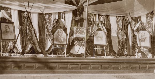 Window display in Bort, Bailey & Co. store on the occasion of a Civil War Veterans' reunion. In the window is a display of images of President Lincoln, General Grant, General Sherman and another Civil War era general.