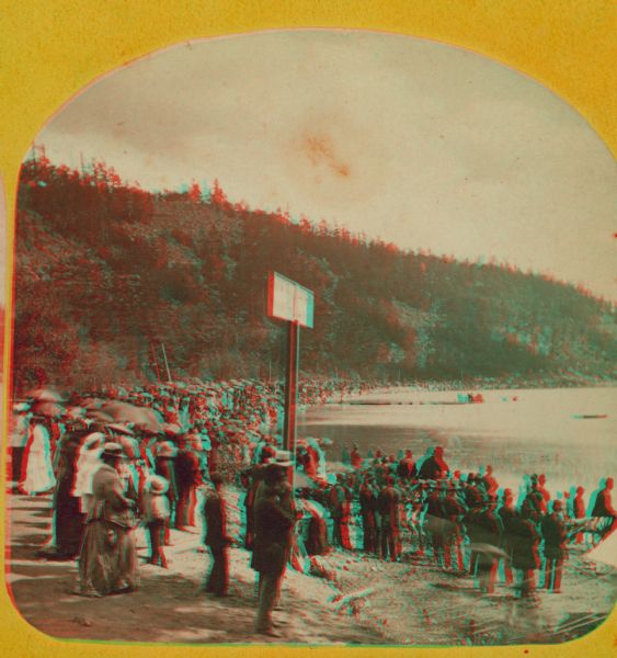 "The Grand Regatta, at Devil's Lake, June 21st & 22nd, 1877." A stereograph showing spectators gathered behind the starter's cannon on Devil's Lake.