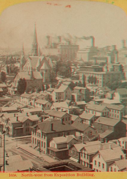 Stereograph of elevated view looking northwest from Exposition Building. There is a church on a street corner on the left, and the Best Brewing Company in the distance.