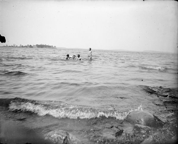 Four boys skinny dip in Lake Mendota.