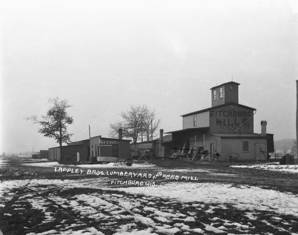 Winter view of exterior of Lappley Bros. Lumberyard and Feed Mill.