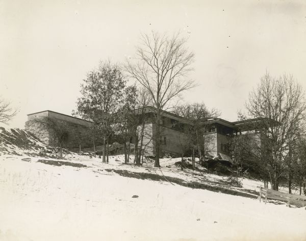 Southeast elevation of Taliesin I, winter 1911-1912. Construction debris is scattered around the base of the building.