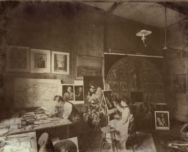 Friedrich Wilhelm Heine at work in his studio. An unidentified woman paints at an easel. Many paintings and sketches surround them. Heine was the Supervisor and Master of Composition for the American Panorama Company.