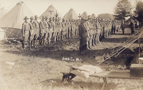 Inspection of Ambulance Company No 1, of which Alvin Steinkopf of Milwaukee was a member, in training at Camp Macarthur. It is not clear which arrow points to Steinkopf.