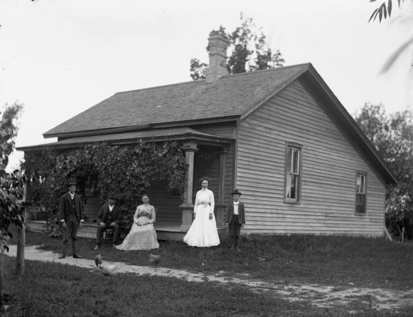 Art, William, Minnie, Clara, and Henry Krause standing in front of the William Krause homestead on Boomer Street.