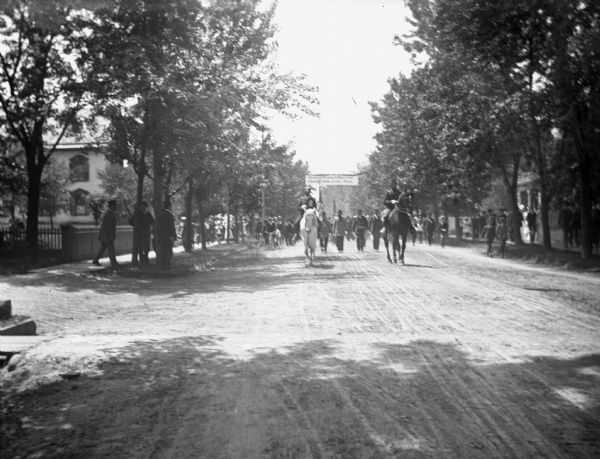 View down street of German soldiers on a march from the depot of the Chicago, Milwaukee, and St. Paul Railroad on their way to Turner Hall.