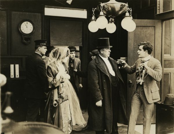 Safecrackers (yeggmen) hired by Sterling, a corrupt Wall Street broker, are caught in the act by the newspaper reporter Dick Carson (played by W. E. Lawrence, holding the candlestick telephone) and his fiancée (Billie West). A police officer (probably played by Jack Dillon) and her father Mr. Berry (W. H. Brown) have also arrived.