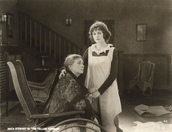 Hilda Nordstrom (played by Anita Stewart) comforts an aged woman in a wheelchair, probably Mother Nordstrom, in a scene still from "The Yellow Typhoon."