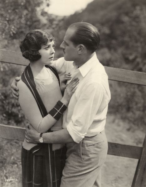 The young chorus girl Eileen (played by Lila Lee) is in the embrace of the millionaire Larry Taylor (Jack Holt) in an outdoor publicity still for William de Mille's "After the Show."