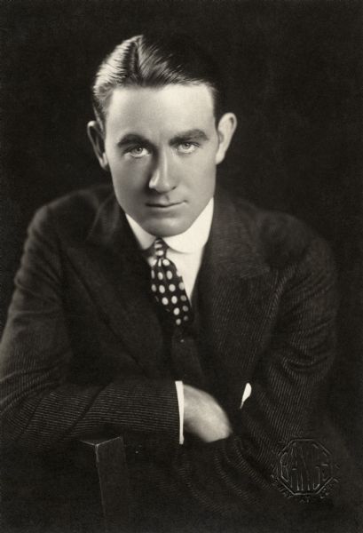Half length seated studio portrait of silent film star Owen Moore looking directly at the camera. This photograph appeared in the January 1914 issue of "Photoplay."