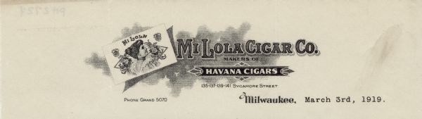 Letterhead of the Mi Lola Cigar Company of Milwaukee, Wisconsin, a Havana cigar company. On the left is the Mi Lola cigar box label with a woman in profile against a triangular background adorned with bunches of flowers.