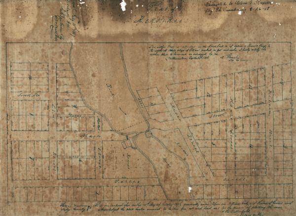 This map shows a plat of the town, local streets, lots, and part of the Rock River. The margins of the map have manuscript annotations in ink.