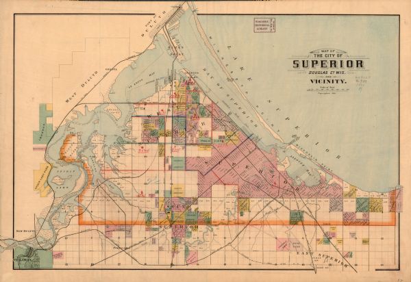 This colorful map shows additions, railroads, docks, streets, established dock lines, marshes, and proposed belt line railroad. The map covers west and south to St. Louis (Wis.), east to McKenty’s Addition, and north to part of Duluth (Minn.). Water depths shown by soundings. Lake Superior, Bay of Superior, Allouez Bay, St. Louis Bay, Oukegama Bay, and Spirit Lake are labeled. The map includes manuscript annotations of city wards in red, and neighborhoods are shown in green, pink, yellow, orange and purple.