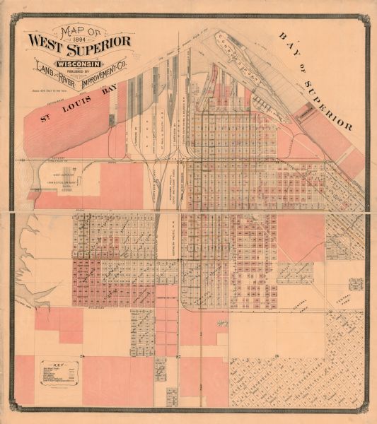This map shows lot and block numbers, railroads, street car tracks, sewers, water mains, gas mains, paved streets, land owned by the Land & River Improvement Co., established dock lines, and parks. The bottom left corner features a key. St. Louis Bay and Bay of Superior are labeled.