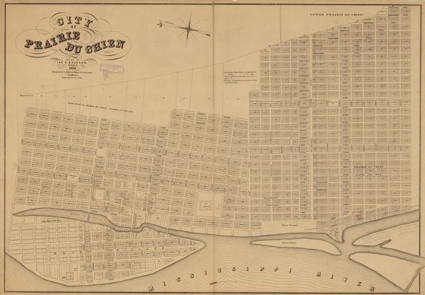 This map shows lot and block numbers, streets, the Mississippi River, Fort Crawford, depot ground, and a graveyard. An old fort location is outlined in red ink and manuscript notations about its destruction are included in the bottom right margin. North is oriented to the left.