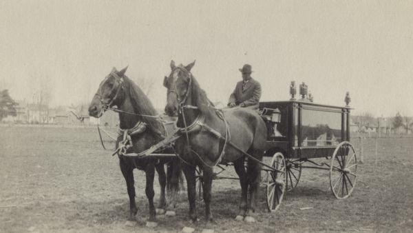 Black Earth hearse drawn by horses. Chris Schanel, the Black Earth undertaker, is driving.