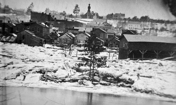 Winter View of Black River Falls View over Back River towards the shoreline covered with ice and snow towards the town of Black River Falls on a winter's day.