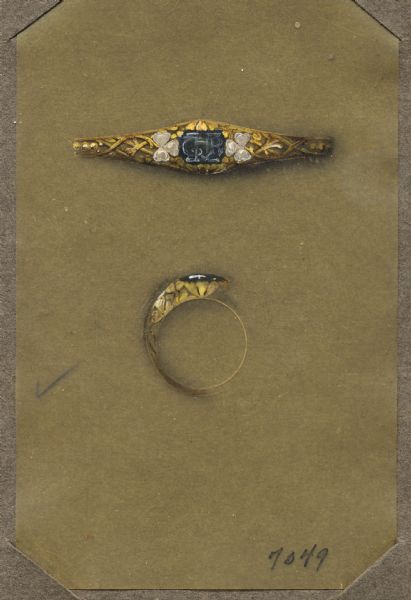 Hand-colored drawing of a design for a ring, done on thin brown paper mounted on cardboard. The design depicts a black stone carved with initials mounted in a foliate openwork gold setting. Smaller heart shaped white stones form a cloverleaf on each side of the central stone. Top and side views are shown. The design is labeled "7349."