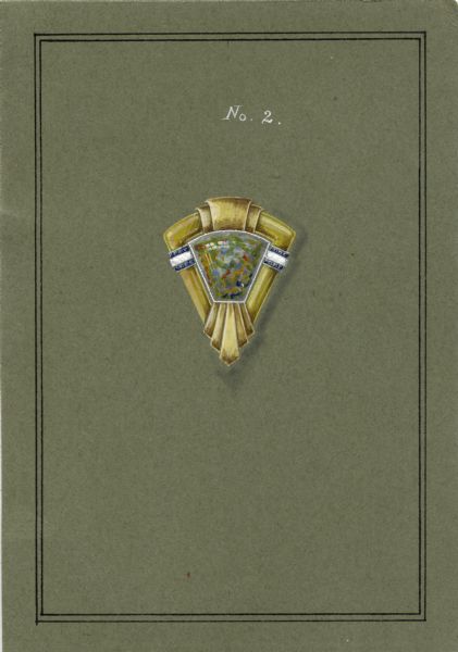 A drawing on green cardboard, labeled No. 2, of a design for a triangular brooch. The mounting of yellow gold holds a multicolored cabochon, possibly an opal. There is a triple band of smaller stones on each side. On the reverse is written "J 3872."