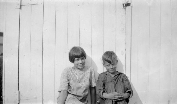 Mary and David O'Dea pose together as they sit on the ground while leaning against their parent's garage door on Park Street.