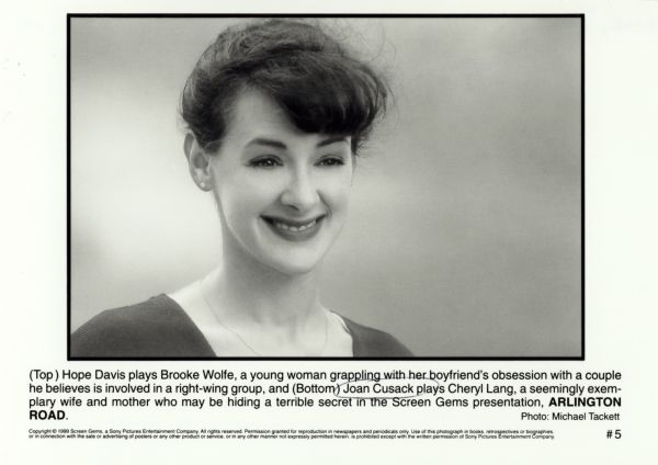 Publicity photograph of Joan Cusack for the film <i>Arlington Road</i>.  She is smiling and has her hair up.