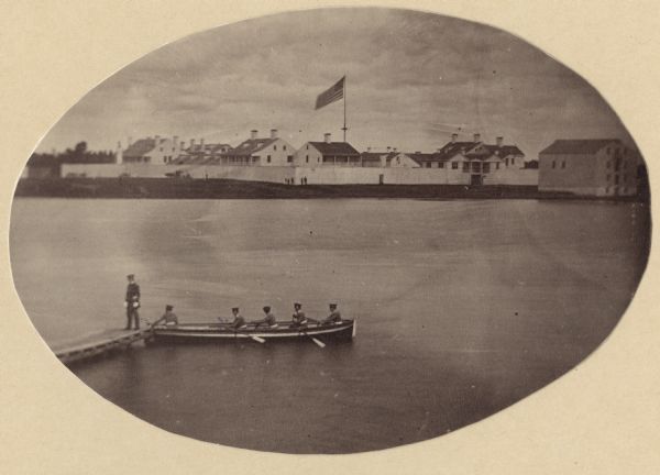 A rare photograph of U.S. Army soldiers stationed at Fort Howard rowing a boat on the Fox River. Fort Howard, built in 1816, was the first in the chain of forts stretching from Fort Winnebago (at Portage) and Fort Crawford at Prairie du Chien in order to protect the early Wisconsin frontier. Because of unhealthy conditions a new fort was built on higher ground. Two years after this photograph was taken, the Fort Howard was decommissioned. Several of its original buildings have been preserved at Heritage Hill State Historical Park.