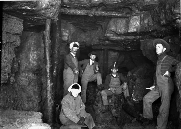 Five miners inside a lead mine.