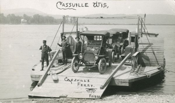 The Cassville Ferry with three cars and passengers, crossing the Mississippi River from Cassville to Turkey River, Iowa.