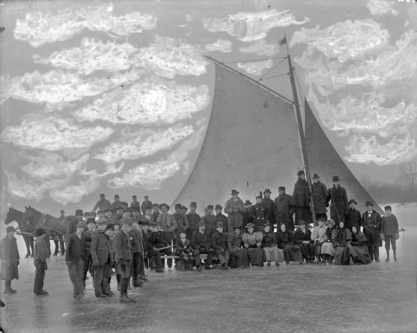 The iceboat was built by the Ranke boys. There are about forty-nine people posing in front of the boat. Almost everyone is wearing ice skates. Names: Fred Beilhartz, Wesley Shelter, George Foehringer, Carl Kleinpell, Walter Kleinpell, William Sturmer, Louisa Kleinpell, Clara Kleinpell, Lena Kleinpell, Agnes Weiss, Oscar Kleinpell, Frances Haberman, Lizzie Haberman, Susie Teasdale, Rose Ohmen, Otto Fahling, Fred Teasdale, Francis Engler, George Johnson, Charley Chase, Frank Ohmen, Lester Walker, George Engler, Lee Woodman, George Schumacher, William Ortscheid, Arthur Engler, James Bennett, Harry Bennett, George Ortscheid, Mike Bernhardt, Herman Kleinpell, Kate Engler, Charley Keibler, Harry Starr, ??? Sharfenstein, George Ranke, Ben Ortscheid, Charley Schnering.