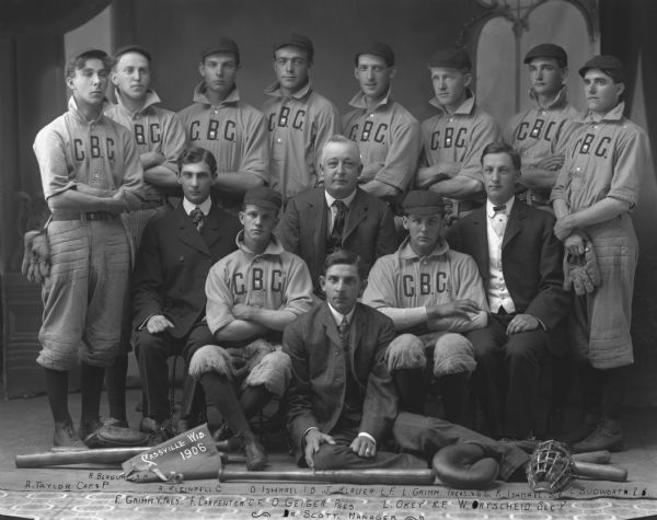 Studio group portrait of the 1906 Cassville Baseball Club, with C.B.C. on their shirts. Team members: R. Bergum, third base; A. Kleinpell, Captain, O. Ishmael, First Base; J. Klauer, Left Field; L. Grimm, Treasurer; R. Ishmael, Sub; C. Budworth, Second Base; F. Grimm, Vice-President; F. Carpenter, Center Field; O. Geiger, President; L. Okey, Right Field; W. Ortscheid, Secretary; Dr. Scott, Manager.