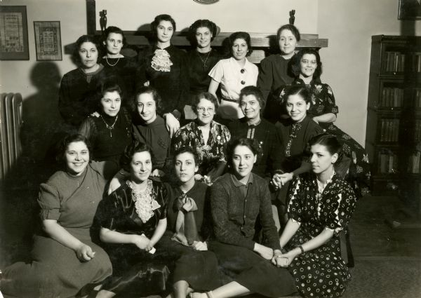 Group portrait of members of the N.B.B.O. ("Nobody's Business But Ours") Club, a social club for young women at Neighborhood House: front row (left): Charlotte Navarra, Stephena Nania; middle row: Sara Navarra, unidentified, Sadie (Mrs. Robert M.) Kent Richmond [?], Gay Braxton, Virginia, sister of GWB [Gay Braxton]; top row: Minnie Navarra, [next 4 unidentified], Mary Lee Griggs, unidentified.