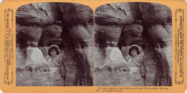 A cutout of a girl placed in the Diamond Grotto in Witches' Gulch. There is graffiti on the rocks in the background. Text at right: "Wanderings Among the Wonders and Beauties of Wisconsin Scenery."