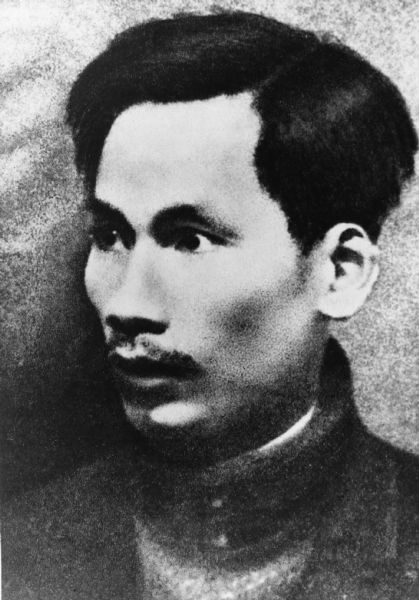 Head and shoulders portrait of Ho Chi Minh, with a shallow depth of field and simple background. Ho Chi Minh looks off to his right.

