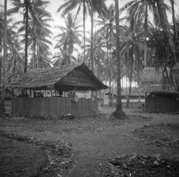 Raining in Coco Grove, officer's quarters, Alamo force. The camp was located on Milne Bay, New Guinea (present day Papua New Guinea).