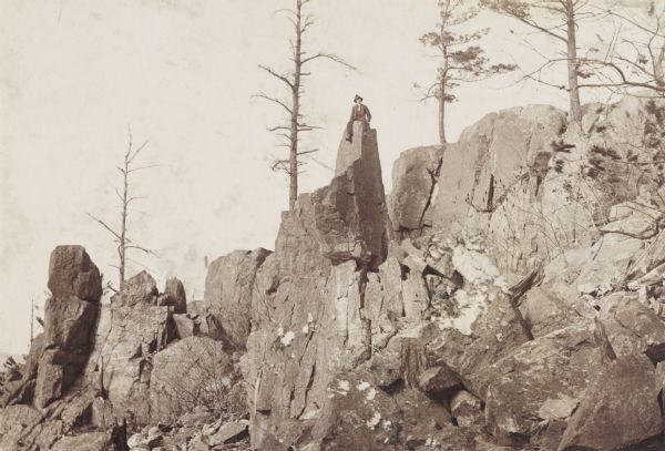 Man sitting atop ridges of quartzite rock in the Baraboo Range.
