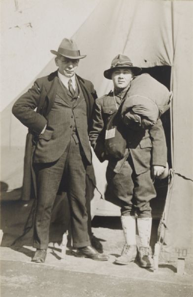 William Rubin, Wisconsin political figure and labor leader, in civilian clothes, visiting his son Abner, in military uniform, at a military camp.