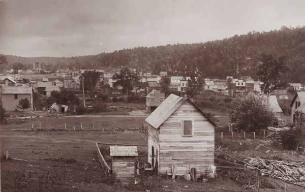 Valley view of town buildings and hillside.