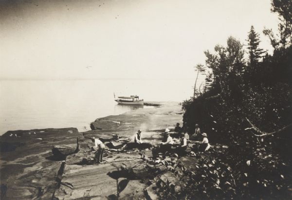 Picnic party on the rocks along the shore, among the Apostle Islands in Lake Superior.
