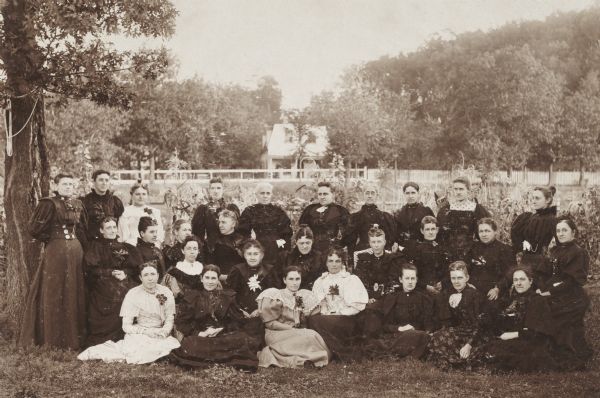 Posed group portrait of twenty-eight women, perhaps a meeting of some local women's organization.