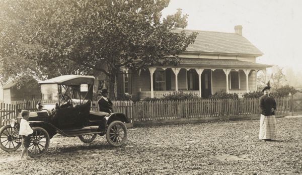 Farmhouse of the Elbert Blow family with a Ford roadster.
