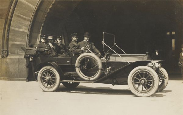 Chief Thomas A. Clancy of the Milwaukee, Wis. Fire Department, with others, posed in an open touring car, as though for a parade.
