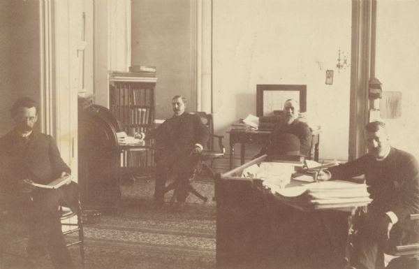 Philip L. Spooner, Wisconsin State Insurance Commissioner, in his office with associates.
