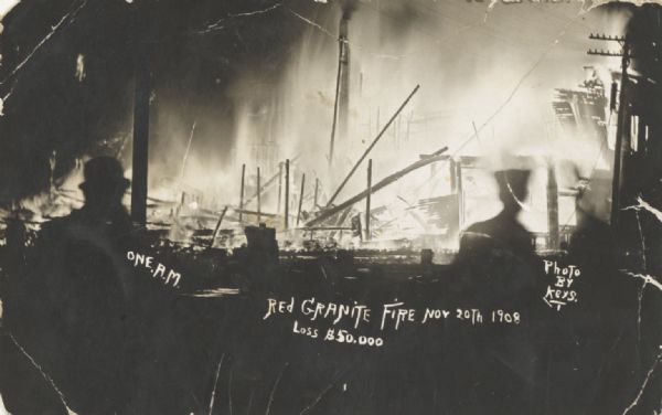 Photographic postcard of dramatic night fire, with ruins and figures in silhouette. Caption reads: "One A.M., Red Granite Night Fire, Nov. 20th 1908, Loss $50,000."