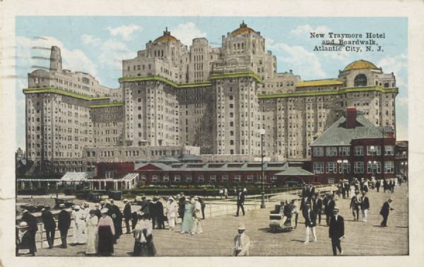Commercial postcard with slightly elevated view of people on the boardwalk at Atlantic City with the Traymore Hotel in the background. Postmarked from Atlantic City, July 2, 1919. Caption reads: "New Traymore Hotel and Boardwalk, Atlantic City, N. J."